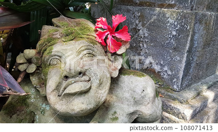 Beautiful artistic Bali stone statue of a Balinese ancient garden statue used as garden decoration, javanese gnome indonesia Beautiful artistic Bali stone statue of a Balinese ancient garden statue used as garden decoration, javanese gnome indonesia 108071413
