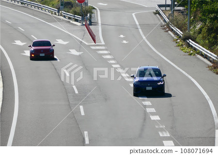 Cars merging onto the main line from the parking area 108071694
