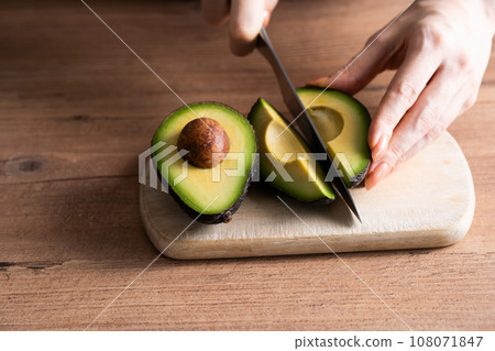 Hands cutting an avocado Hands cutting an avocado 108071847
