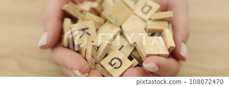 Hands of woman with neat manicure holding cubes with letters 108072470