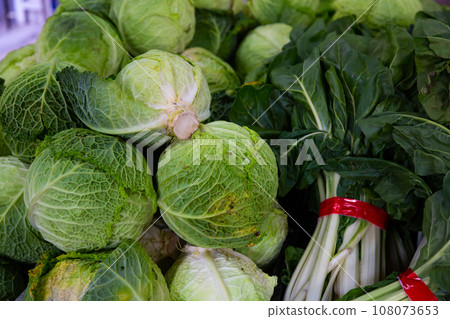 Green leafy vegetables on market counter Green leafy vegetables on market counter 108073653