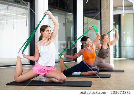 Women doing stretches with resistance bands 108073871