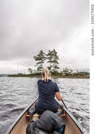blonde Girl Canoe ride exploring nature on morning mist Kejimkujik National Park Wilderness Nova Scotia Canada blonde Girl Canoe ride exploring nature on morning mist Kejimkujik National Park Wilderness Nova Scotia Canada 108073908