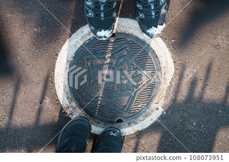 Hakodate city manhole cover with snow in winter season. Hakodate in one of landmark and popular for tourists attractions in Hokkaido, Japan. Travel and Vacation concept 108073951