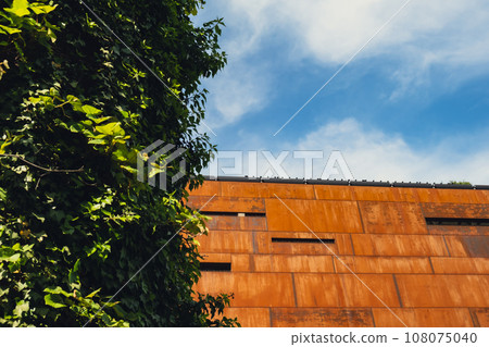 Facade of European Solidarity Centre building, Europejskie Centrum Solidarnosci in Gdansk Poland. Exterior on blue sky background. Monument to the fallen Shipyard Workers 1970 Old town. Museum Facade of European Solidarity Centre building, Europejskie Centrum Solidarnosci in Gdansk Poland. Exterior on blue sky background. Monument to the fallen Shipyard Workers 1970 Old town. Museum 108075040