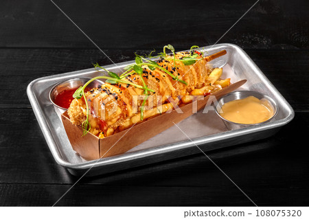 Classic sausage corn dog with french fries, sweet chili and cheddar sauces 108075320