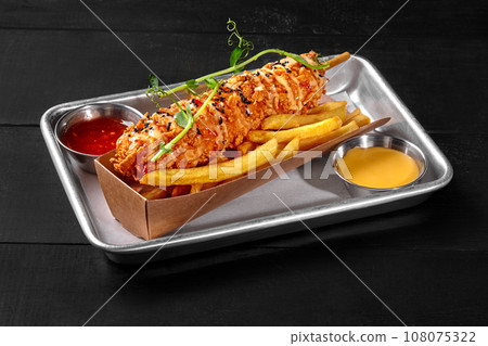 Corndog with smoked sausage in batter with potato fries and two sauces 108075322