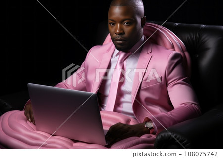 Creative portrait of respectable African American man in elegant pink suit with laptop sitting in big leather office chair. Confident boss, successful entrepreneur literally melting at hot hard work. 108075742