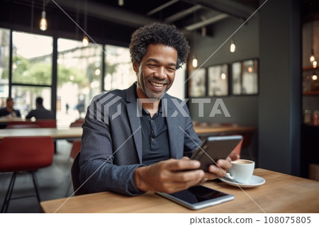 Cheerful African American man in casual clothes with smartphone and cup of coffee sitting in cafe. Smiling mature man, successful entrepreneur or employee working online. Remote work concept. Cheerful African American man in casual clothes with smartphone and cup of coffee sitting in cafe. Smiling mature man, successful entrepreneur or employee working online. Remote work concept. 108075805