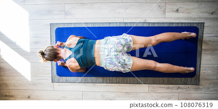top view of woman doing yoga on mat 108076319
