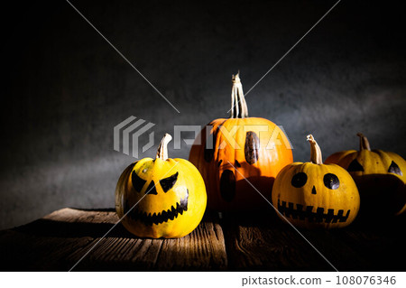 scary funny Halloween pumpkins on wooden table 108076346