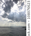 Seascape with light shining through the clouds 108076623