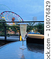 Champagne glasses on the terrace and scenery of the Ferris wheel 108076829