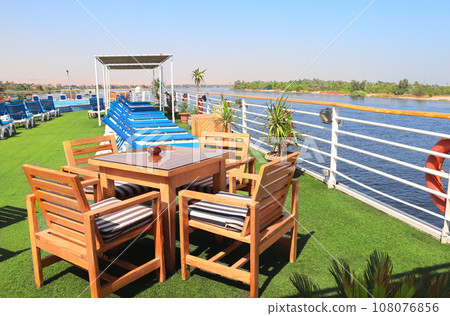 Sundesk on cruise ship. A place to relax, tables and lounger on the deck. Luxury Nile Cruise, Egypt, Africa. Summer vacation, relaxing on cruise ships 108076856