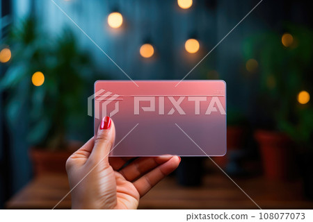 Pink mockup of a business card or bank card in the hands of a woman Pink mockup of a business card or bank card in the hands of a woman 108077073