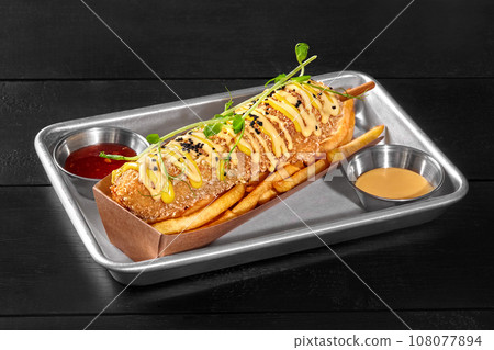 Smoked sausage corn dog with french fries, sweet chili and cheddar sauces Smoked sausage corn dog with french fries, sweet chili and cheddar sauces 108077894