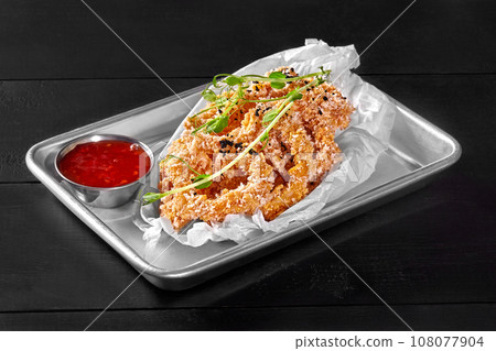 Deep-fried squid rings in tempura with sweet chili sauce 108077904