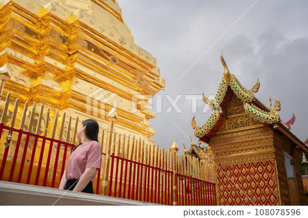 asian woman travel and see to gold temple at chiangmai Thailand in summer season asian woman travel and see to gold temple at chiangmai Thailand in summer season 108078596