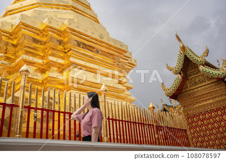 asian woman travel and see to gold temple at chiangmai Thailand in summer season asian woman travel and see to gold temple at chiangmai Thailand in summer season 108078597