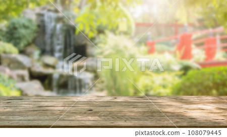 Empty wood table top with abstract blur park garden pond background Empty wood table top with abstract blur park garden pond background 108079445