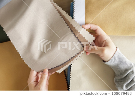 female designer with fabric color samples choosing textile for curtains female designer with fabric color samples choosing textile for curtains 108079493