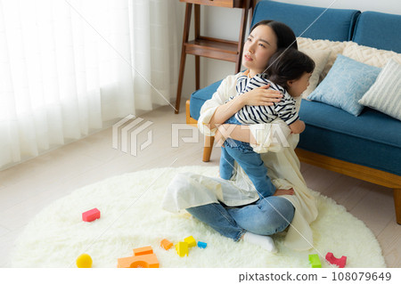 A mother holding a child 108079649