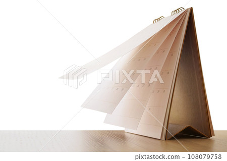 Calendar page flipping sheet on wood table isolated on white background business schedule planning appointment meeting concept 108079758