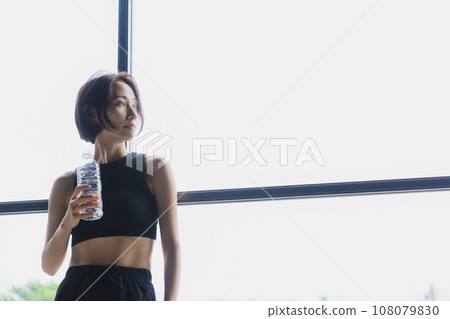 A woman with a plastic bottle 108079830