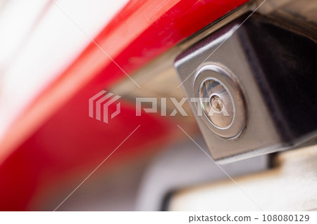 Red car rear view camera close up for parking assistance 108080129