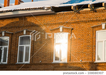 Street with houses cold weather. Snow day in winter. Building in city center covered with snow. 108080307
