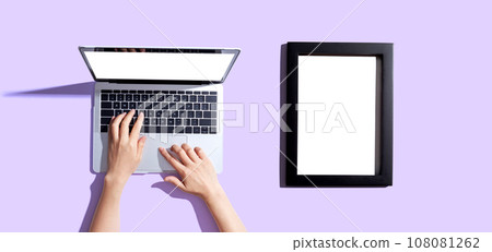 Laptop computer with a blank photo frame 108081262