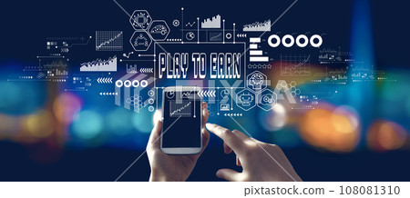 Play to Earn theme with person using a smartphone at night 108081310