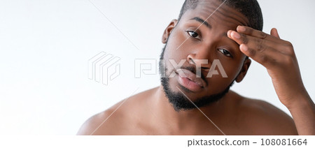 Man skincare. Morning routine. Confident handsome shirtless guy touching perfect smooth soft face skin isolated on white background empty space. 108081664