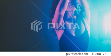 Dance energy performance. Graceful woman. Sensual emotional lady moving in haze shadow projector blue light dark indigo background copy space. Dance energy performance. Graceful woman. Sensual emotional lady moving in haze shadow projector blue light dark indigo background copy space. 108081750