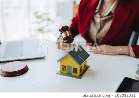 portrait of an asian man, Agent, buy and sell land, property tax, show the concept of protecting the house to insure the risk of damage to the home. 108082331