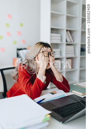 Portrait of business owner, woman using computer and financial statements Anxious expression on expanding the market to increase the ability to invest in business. Portrait of business owner, woman using computer and financial statements Anxious expression on expanding the market to increase the ability to invest in business. 108082409