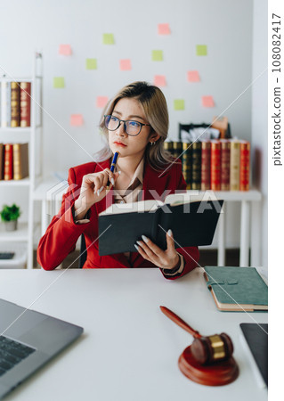 Portrait of a Asian woman lawyer studying a lawsuit for a client before going to court. Portrait of a Asian woman lawyer studying a lawsuit for a client before going to court. 108082417