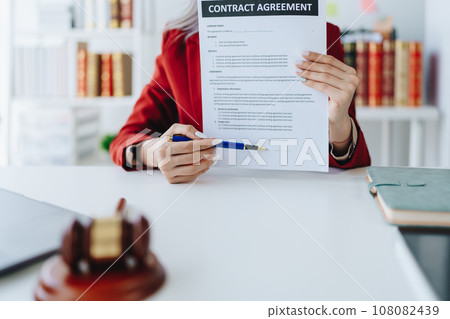 The lawyer with a client discussing contract paper, a Business lawyer working about legal legislation in the courtroom to help their customer, contract and agreement concept The lawyer with a client discussing contract paper, a Business lawyer working about legal legislation in the courtroom to help their customer, contract and agreement concept 108082439