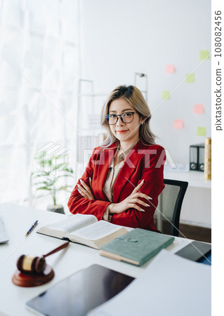 Portrait of a Asian woman lawyer studying a lawsuit for a client before going to court. 108082456