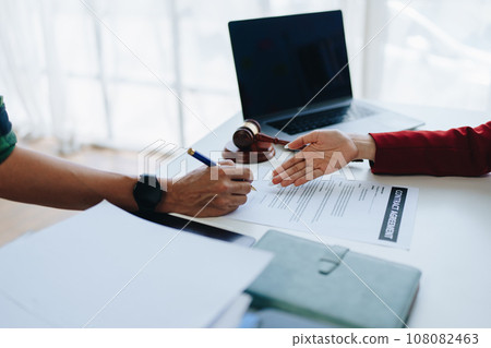 The lawyer with a client discussing contract paper, a Business lawyer working about legal legislation in the courtroom to help their customer, contract and agreement concept The lawyer with a client discussing contract paper, a Business lawyer working about legal legislation in the courtroom to help their customer, contract and agreement concept 108082463