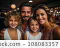 Portrait of family of parents and children girls in cafe 108083357