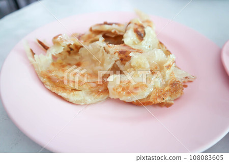 roti or naan , fried roti with sweetened condensed milk roti or naan , fried roti with sweetened condensed milk 108083605