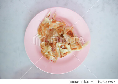 roti or naan , fried roti with sweetened condensed milk roti or naan , fried roti with sweetened condensed milk 108083607