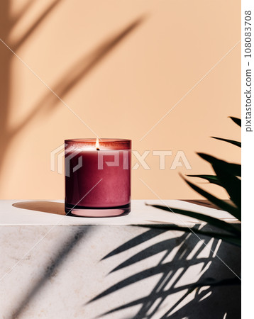 Burning candle in glass jar, vivid studio background with decor and shadows, candle mockup Burning candle in glass jar, vivid studio background with decor and shadows, candle mockup 108083708