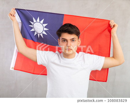 Joyful female fan of favorite team of Taiwan with the national flag in her hands 108083829