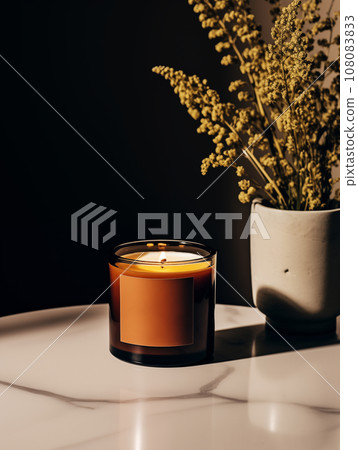 Burning candle in glass jar, vivid studio background with decor and shadows, candle mockup Burning candle in glass jar, vivid studio background with decor and shadows, candle mockup 108083833