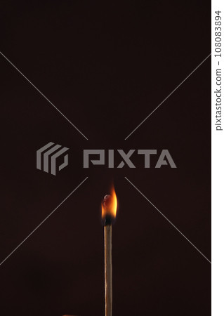 a lighted match on a dark background a lighted match on a dark background 108083894