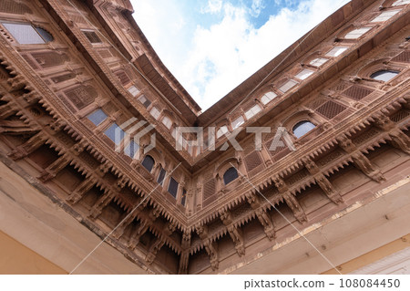 Look up at the red and yellow castle standing majestically on the hill. 108084450