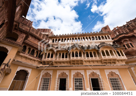 Look up at the red and yellow castle standing majestically on the hill. 108084451