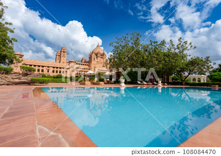 There is a garden and swimming pool outside the hotel. 108084470